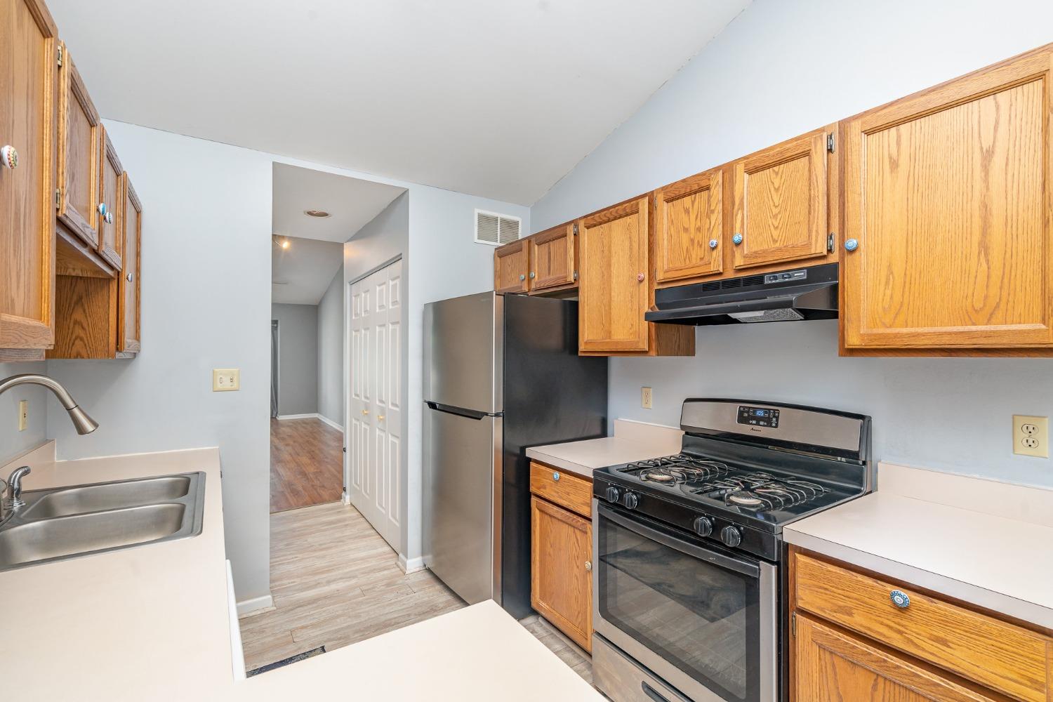 225 Clinton Street Lowell, IN 46356 - Photo 12 of 27 a kitchen with stainless steel appliances granite countertop a refrigerator stove and sink