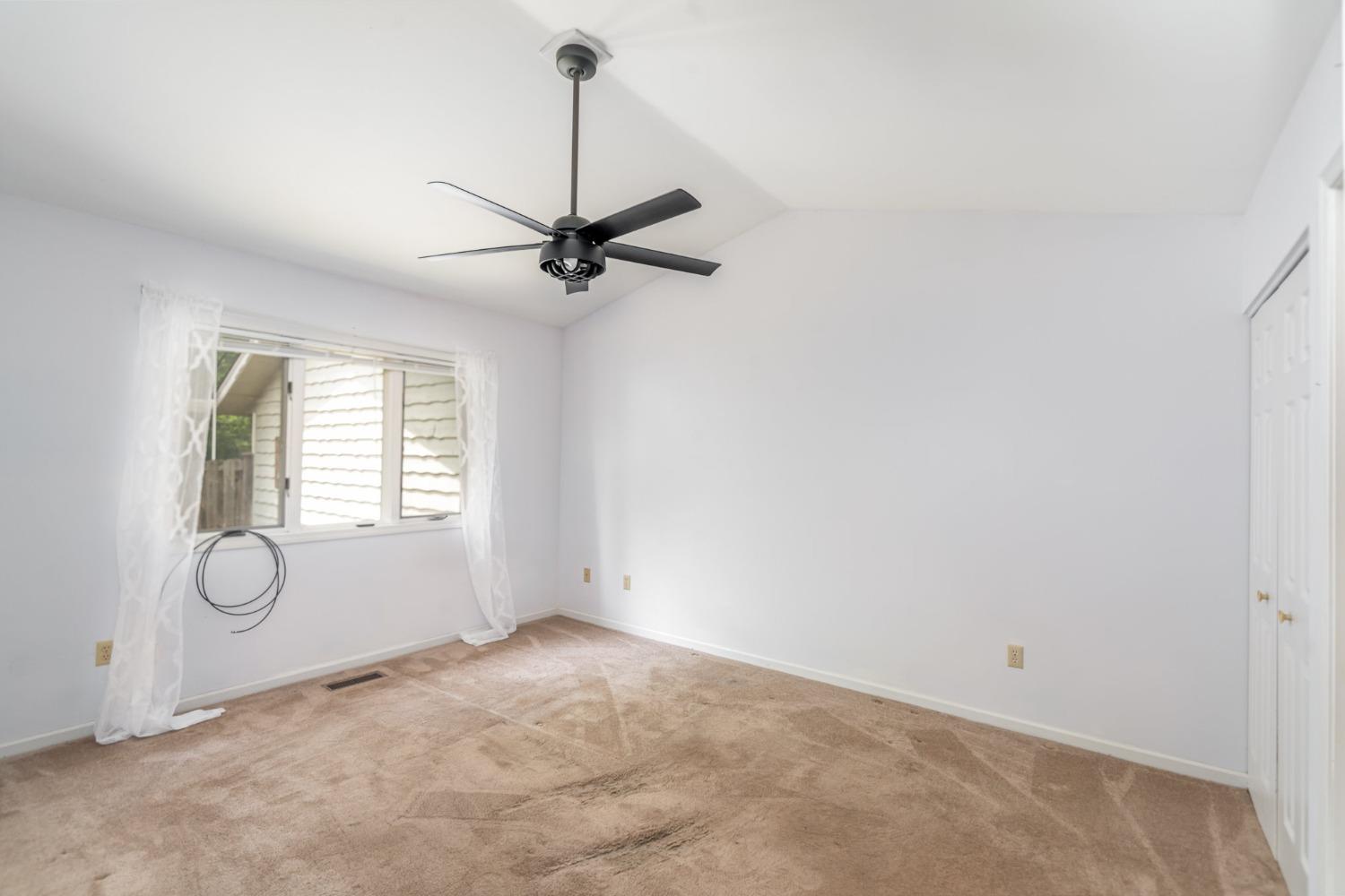 225 Clinton Street Lowell, IN 46356 - Photo 14 of 27 a view of a room with a chandelier fan and windows