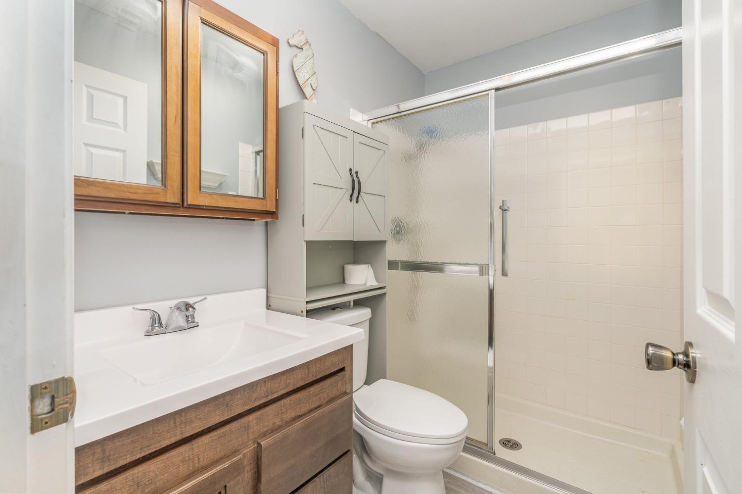 225 Clinton Street Lowell, IN 46356 - Photo 20 of 27 a bathroom with a sink a toilet and shower
