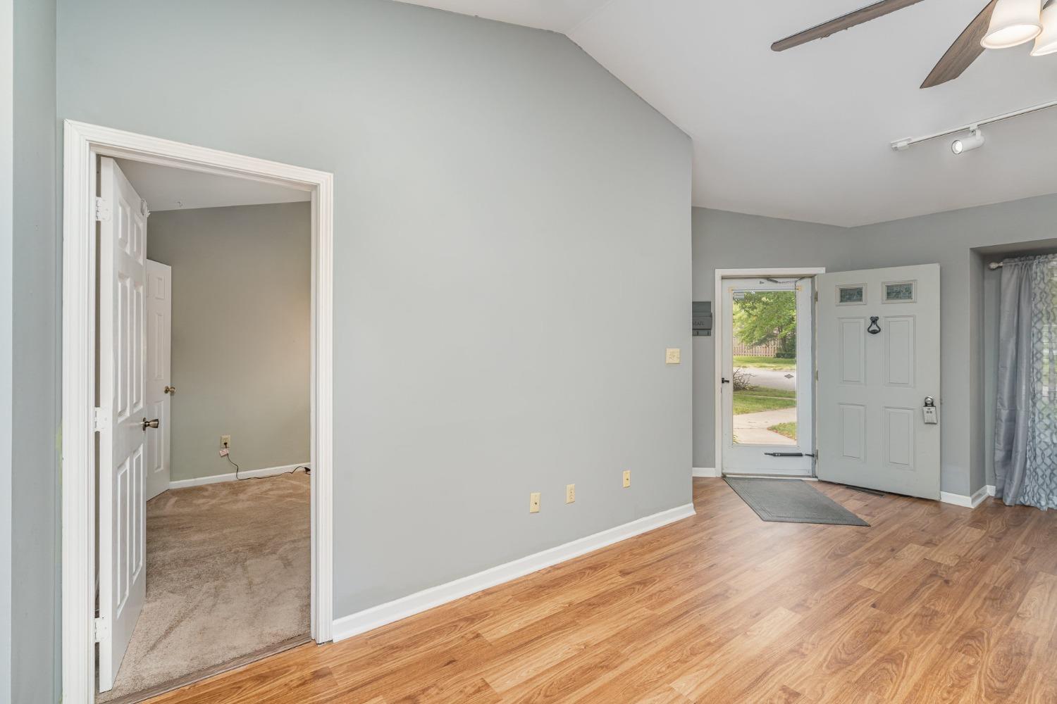 225 Clinton Street Lowell, IN 46356 - Photo 8 of 27 an empty room with wooden floor and mirror