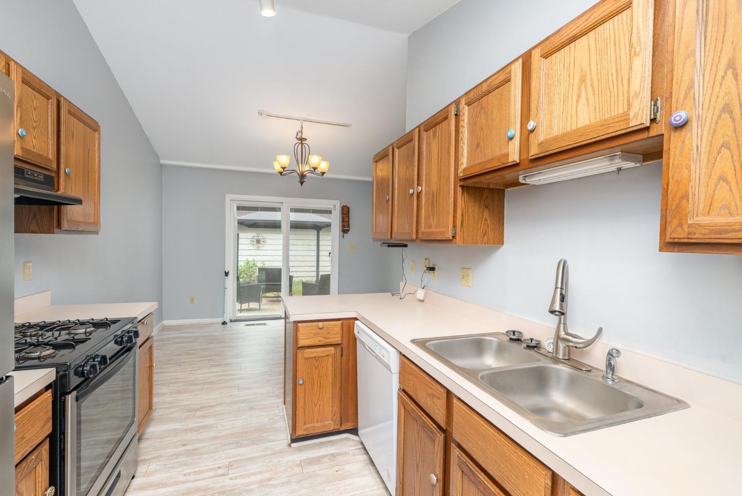 225 Clinton Street Lowell, IN 46356 - Photo 10 of 27 a kitchen with stainless steel appliances granite countertop a sink stove and cabinets