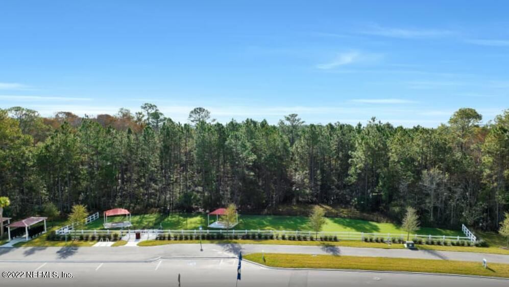 674 Blind Oak Cir Street St. Augustine, FL 32095 - Photo 15 of 21 a view of a swimming pool and trees in the background