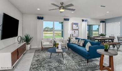 674 Blind Oak Cir Street St. Augustine, FL 32095 - Photo 2 of 21 a living room with furniture and a flat screen tv
