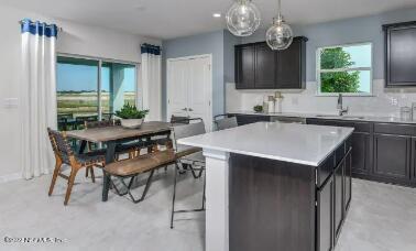 674 Blind Oak Cir Street St. Augustine, FL 32095 - Photo 6 of 21 a kitchen with a table chairs sink and cabinets