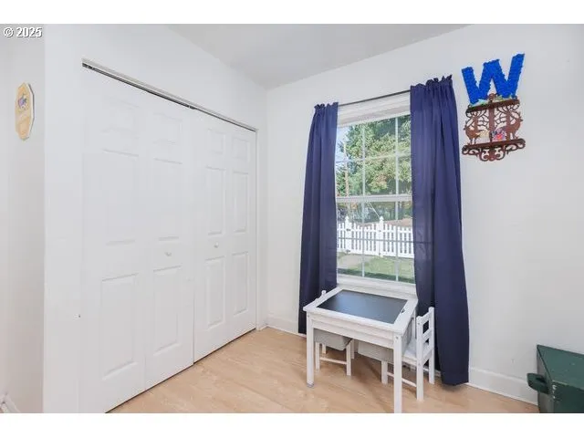 a bedroom with a bed a table and chairs