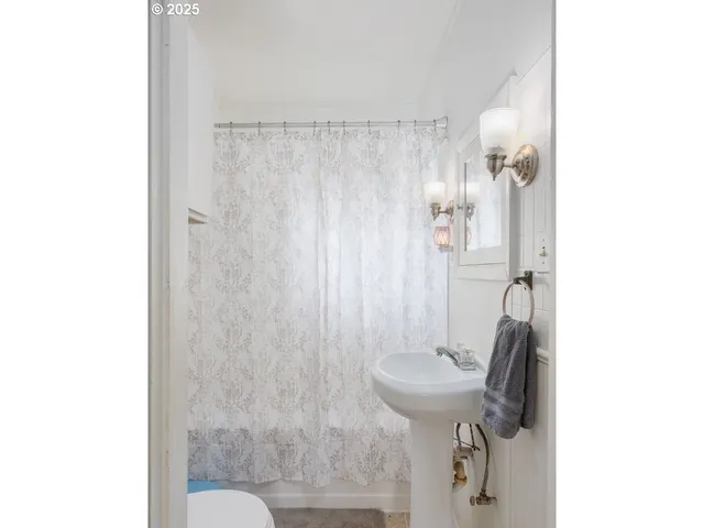 a white toilet sitting next to a shower curtain
