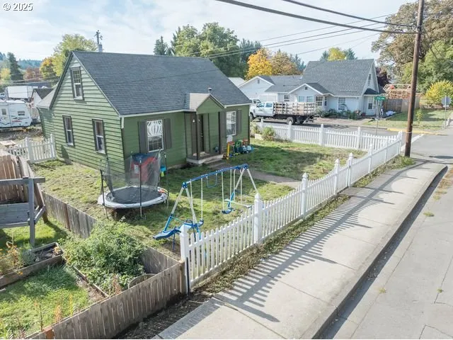 a view of house with backyard and sitting area