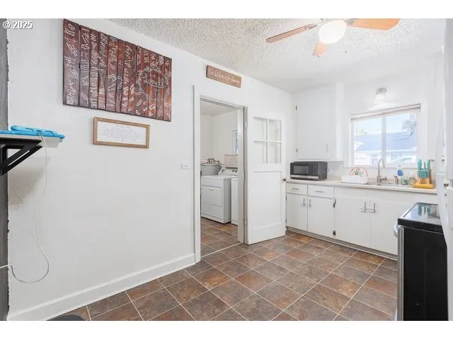 a kitchen with a refrigerator and white cabinets