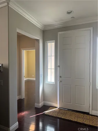 an empty room with wooden floor and closet