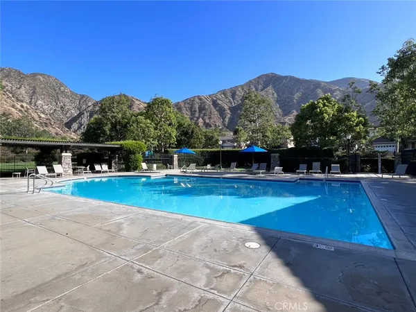 a view of swimming pool with a yard and mountain view