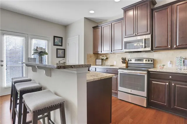 a kitchen with stainless steel appliances granite countertop a refrigerator sink and cabinets
