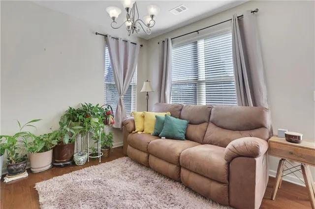 a living room with furniture and a chandelier
