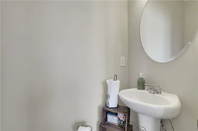 a bathroom with a sink a mirror and a toilet