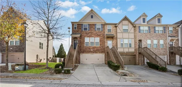 a front view of a house with a garden and plants