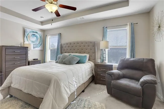 a bedroom with a bed and ceiling fan