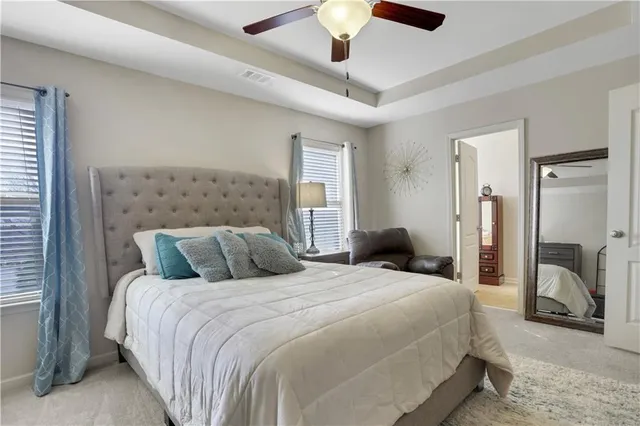 a bedroom with a bed and a large mirror