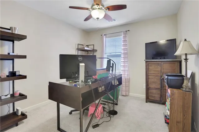 a work room with furniture and a flat screen tv