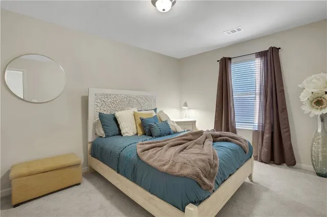 a bedroom with a bed couch and a window