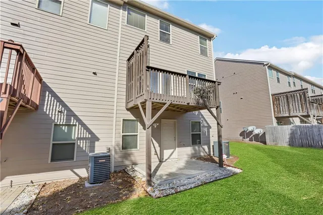 a view of a house with a yard and deck