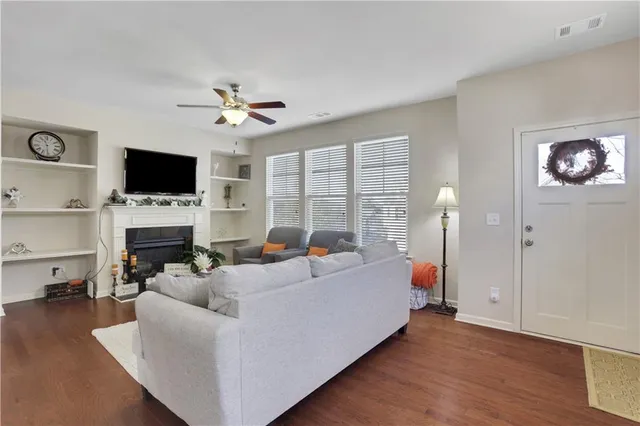 a living room with furniture a fireplace and a flat screen tv