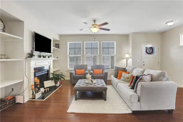 a living room with furniture a flat screen tv and a fireplace