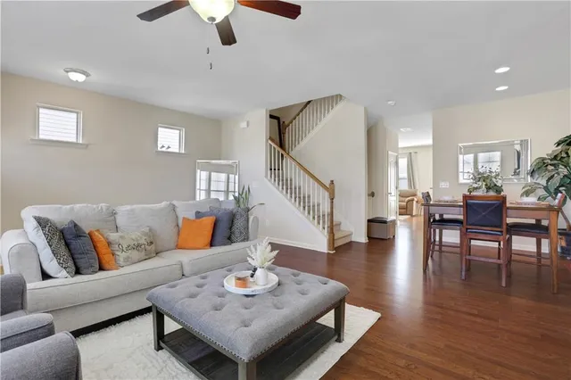 a living room with furniture and wooden floor