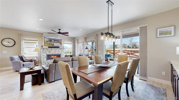 a living room with furniture a fireplace and a large window