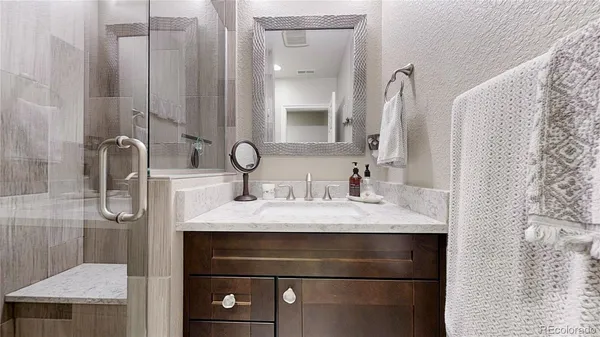 a bedroom with a bed and a night stand