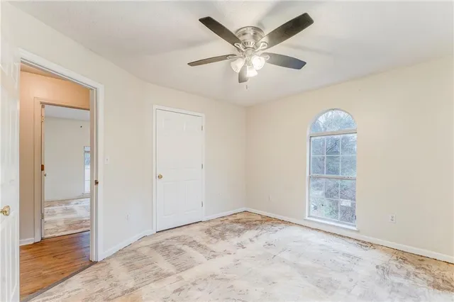 a view of large house with a big yard and large trees