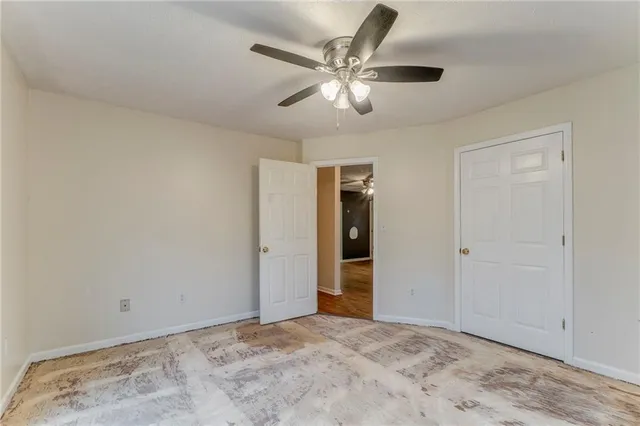 a front view of house with yard and trees in the background