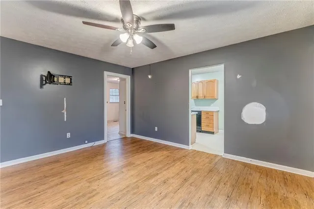 a view of an empty room with cabinet and window