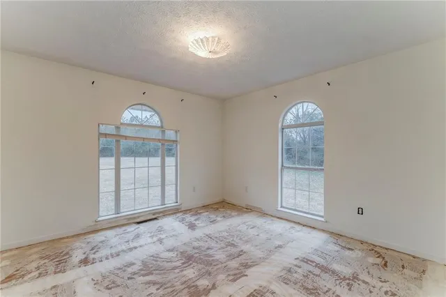 a kitchen with granite countertop stainless steel appliances white cabinets and a sink