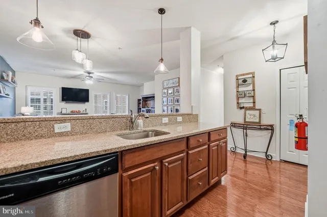 a kitchen with a sink appliances and a counter top space