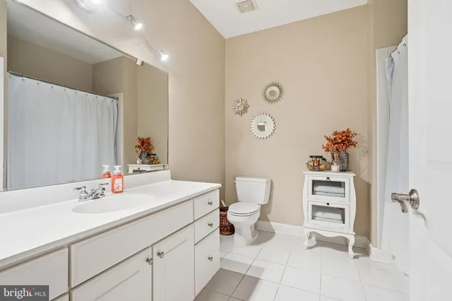 a bathroom with a sink toilet and a mirror