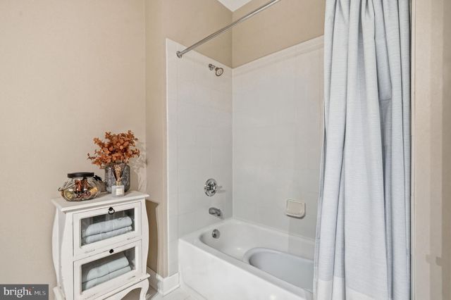 a bathroom with a bathtub with a shower