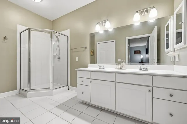 a bathroom with a double vanity sink mirror and