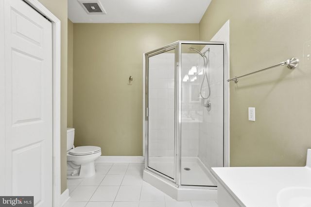 a bathroom with a glass shower door