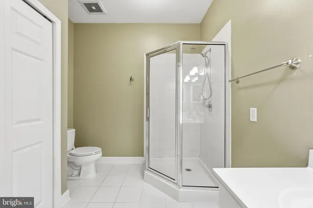 a bathroom with a glass shower door