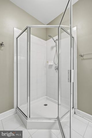 a bathroom with a glass shower door