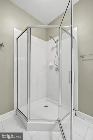 a bathroom with a glass shower door