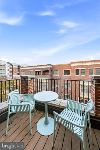 a view of a balcony with wooden floor table and chairs