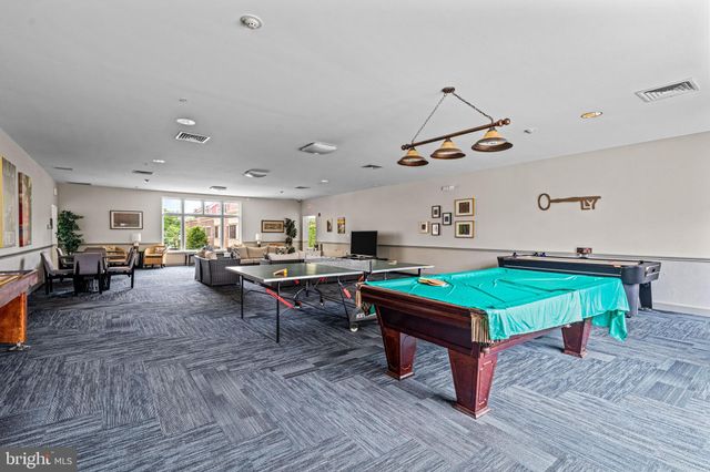a view of a patio with table and chairs with wooden floor and fence