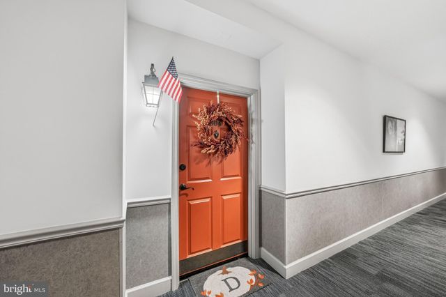 a view of a hallway with paintings on the wall