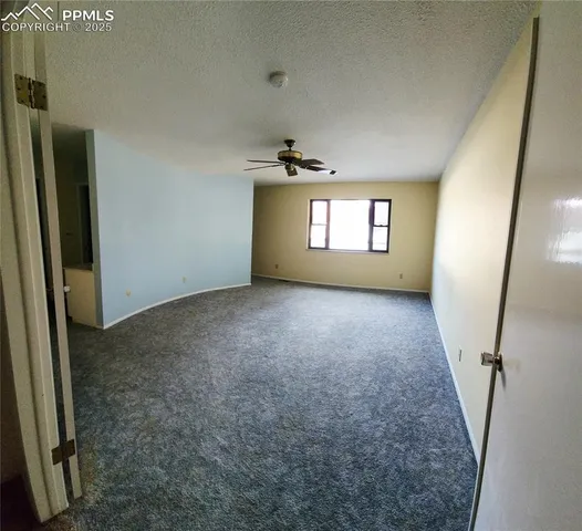 an empty room with windows and entrance