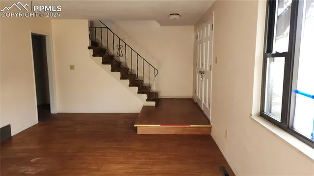 a view of entryway and hall with wooden floor