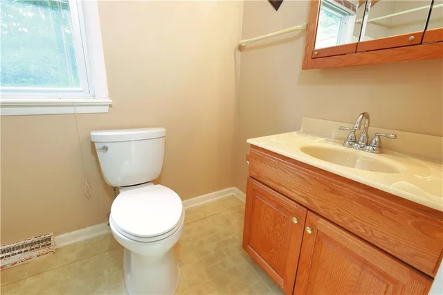 a bathroom with a sink toilet and mirror