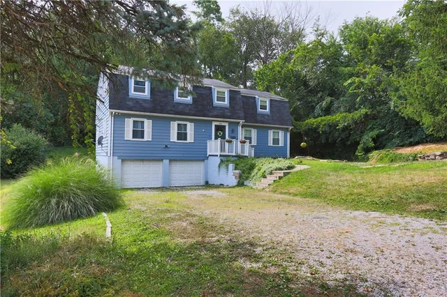 a view of a house with a yard and potted plants