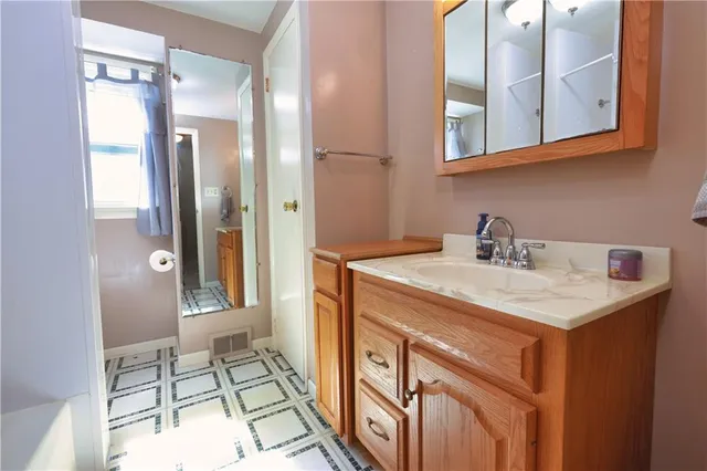 a bathroom with a bath tub with a shower
