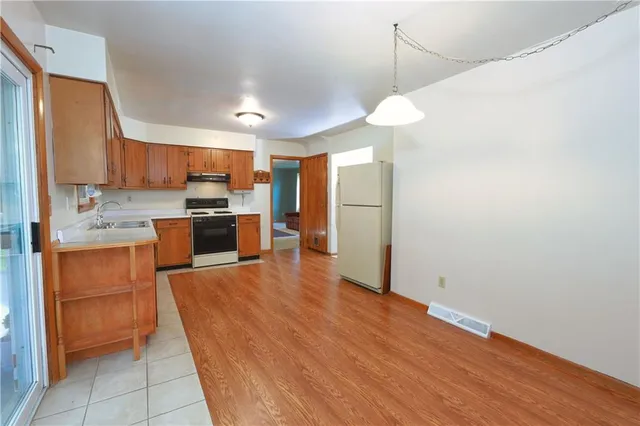 a kitchen with stainless steel appliances granite countertop a refrigerator sink and cabinets