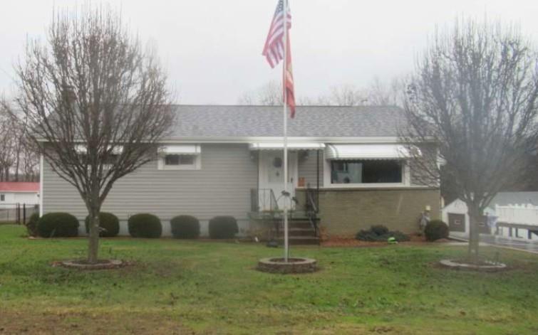 1421 Davidson Street Wampum, PA 16157 - Photo 1 of 3 a front view of a house with a yard